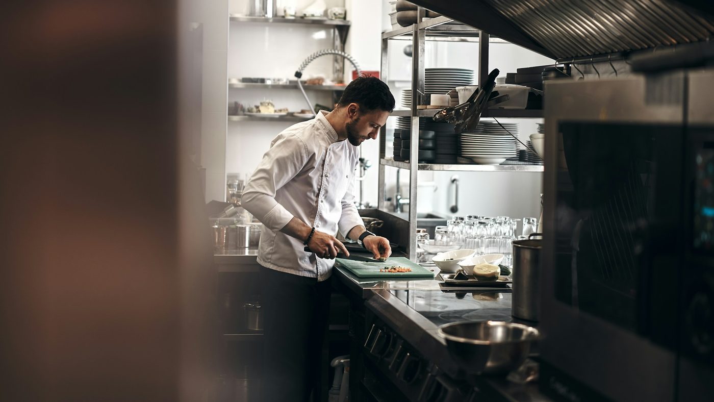 A chef preparing food in a restaurant kitchen