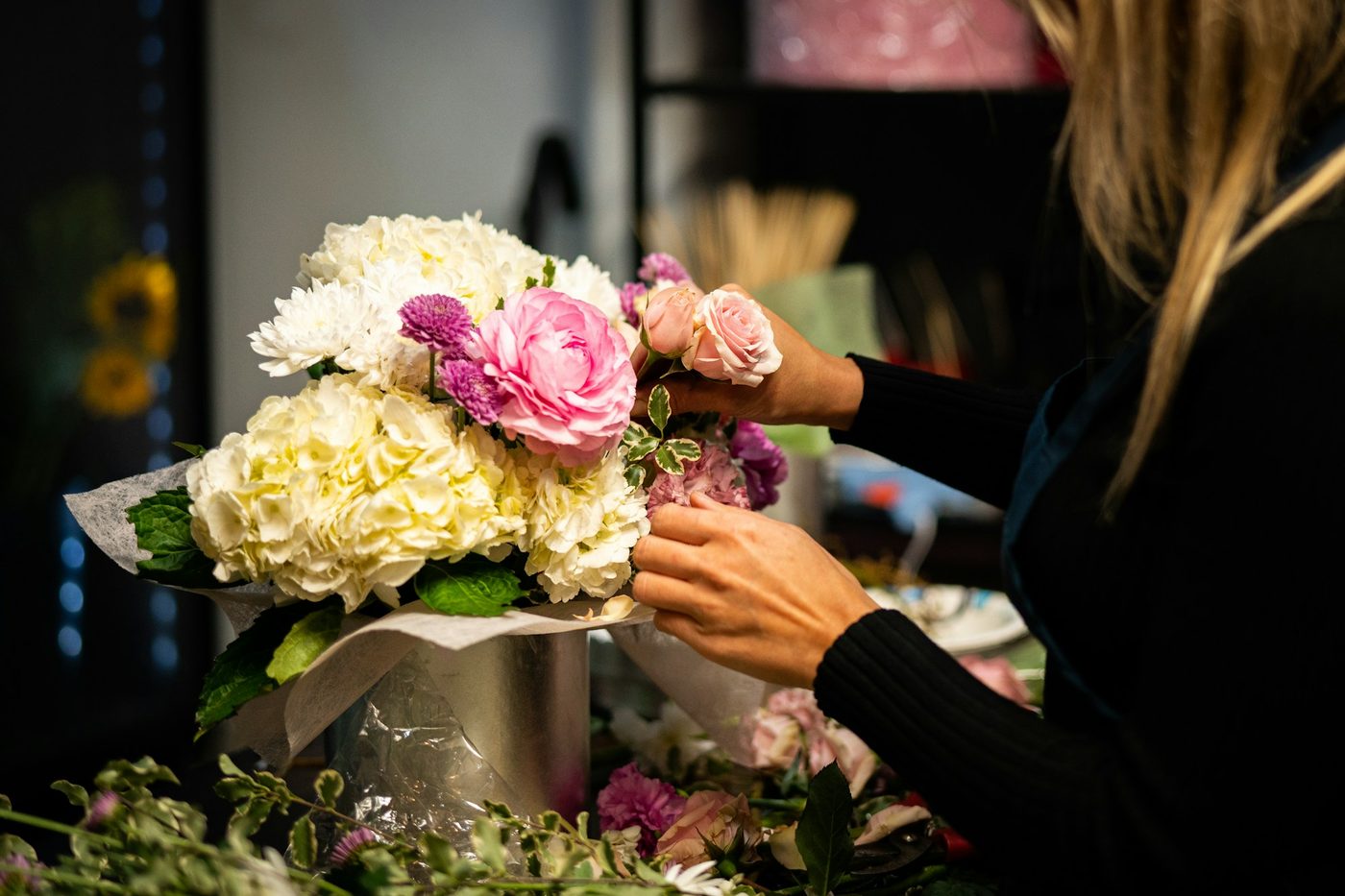 A florist arranging a bouquet of flowers