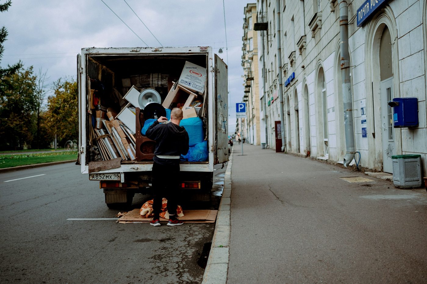 A worker loading furniture into a moving truck