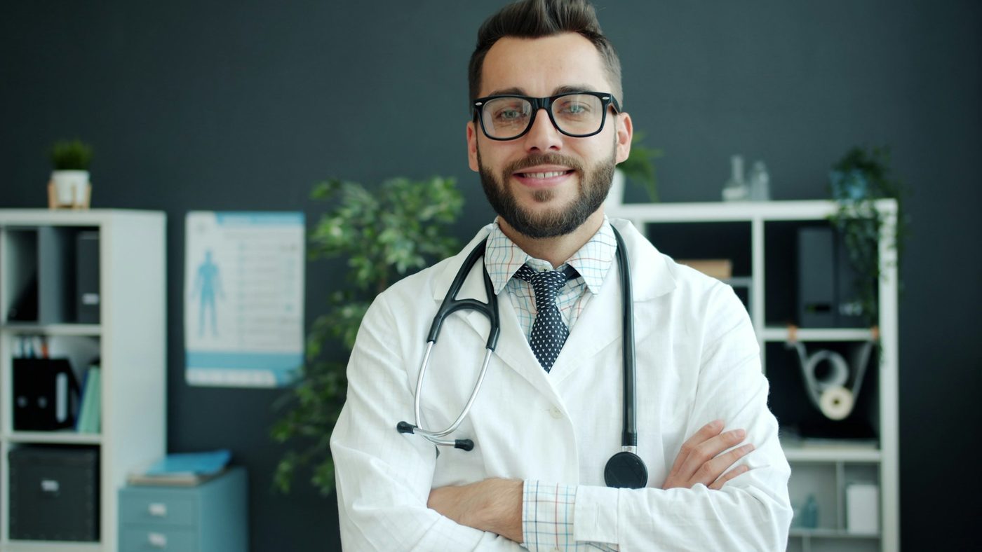 A smiling doctor with a stethoscope in a clinic